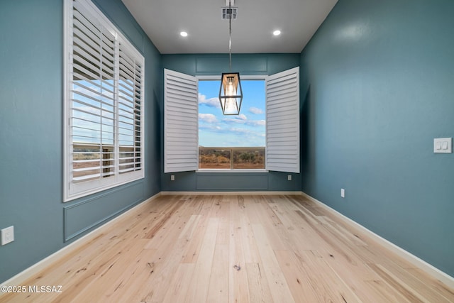 unfurnished dining area featuring light hardwood / wood-style floors