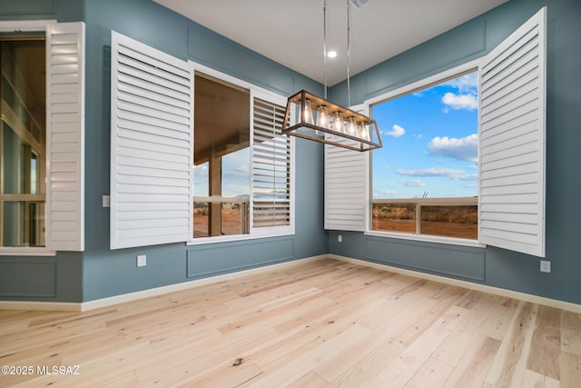 unfurnished room with hardwood / wood-style flooring