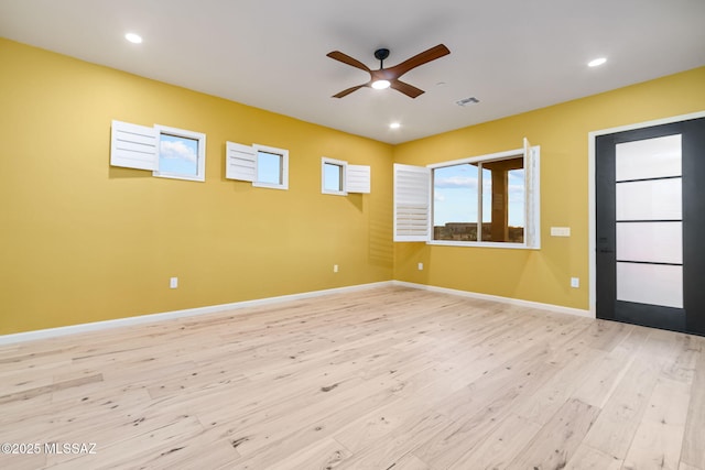 empty room featuring light hardwood / wood-style floors and ceiling fan