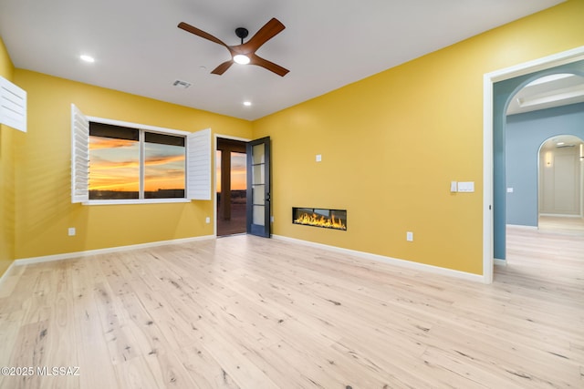 spare room with light hardwood / wood-style flooring and ceiling fan