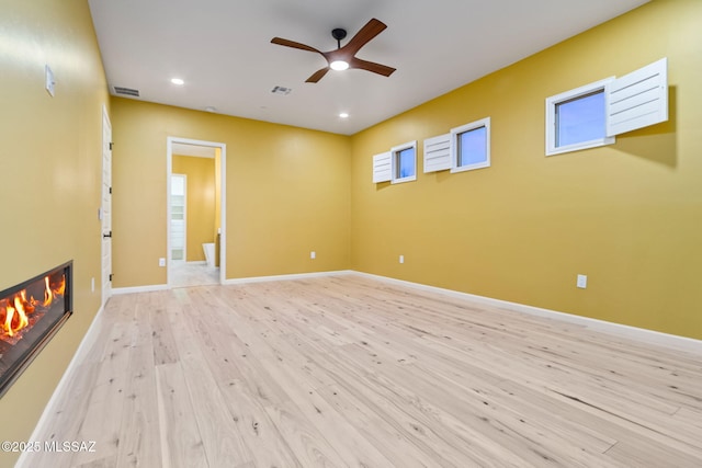 spare room with light hardwood / wood-style floors and ceiling fan