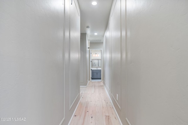 hall with light hardwood / wood-style floors