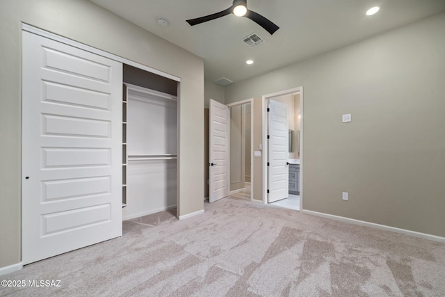 unfurnished bedroom with ceiling fan, connected bathroom, light carpet, and a closet