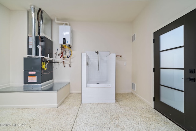 bathroom featuring heating unit and tankless water heater