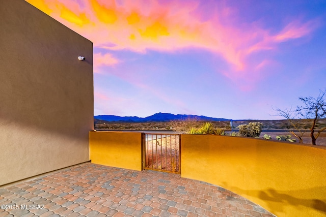 patio terrace at dusk with a mountain view