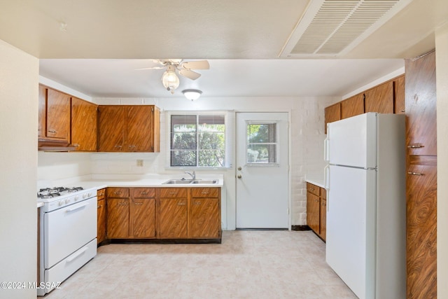 kitchen featuring ceiling fan, white appliances, sink, and light tile patterned floors