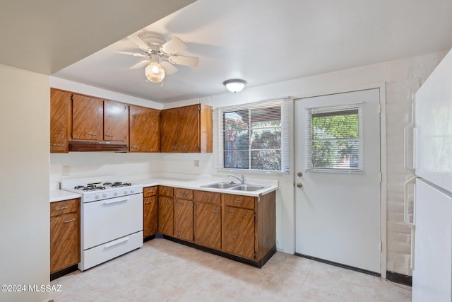 kitchen with ceiling fan, white appliances, and sink