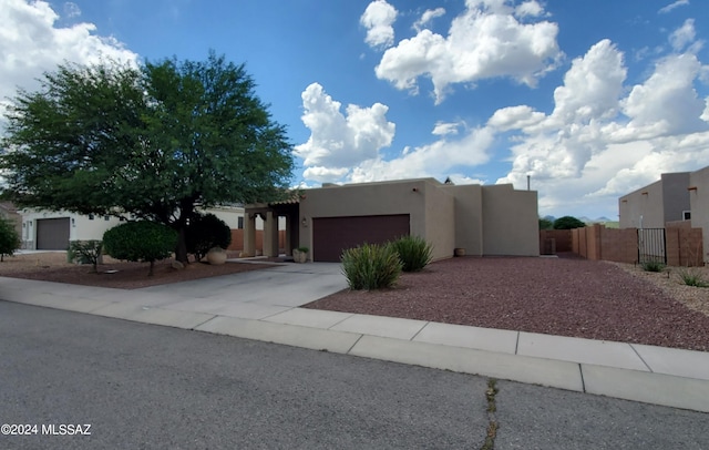 pueblo-style home with a garage