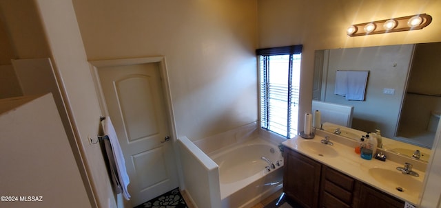 bathroom featuring vanity and a tub