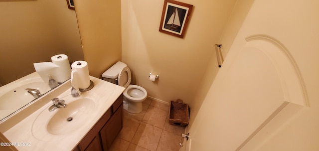 bathroom with tile patterned flooring, vanity, and toilet