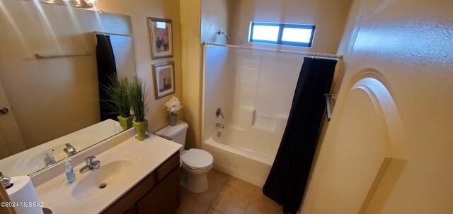 full bathroom featuring shower / bath combination with curtain, tile patterned floors, vanity, and toilet