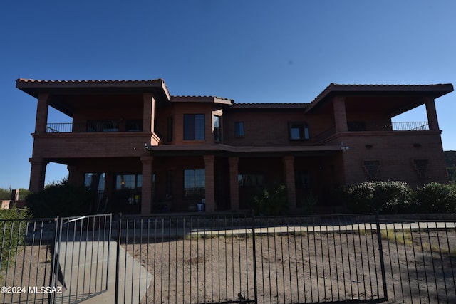 back of house featuring a balcony