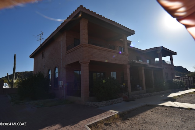 back of house featuring a balcony