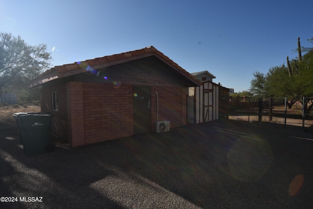 view of side of home with ac unit