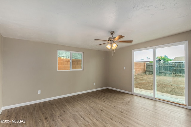 unfurnished room featuring ceiling fan and light wood-type flooring