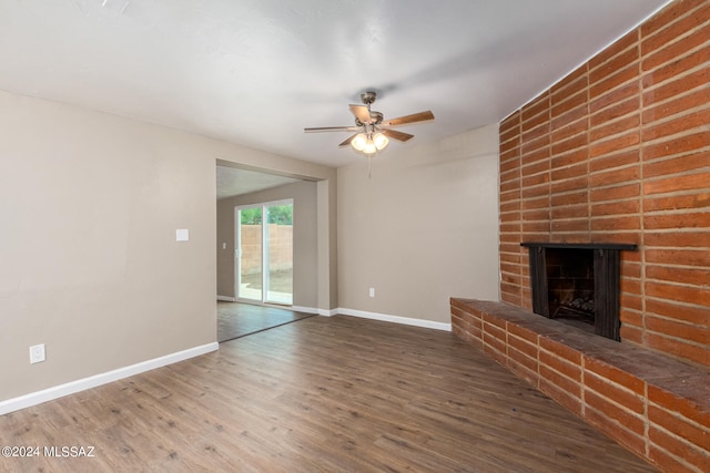 unfurnished living room featuring wood-type flooring, a fireplace, and ceiling fan