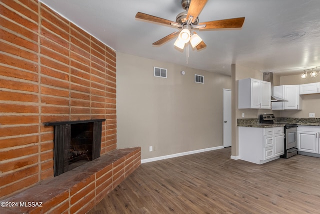 kitchen with white cabinetry, hardwood / wood-style flooring, and stainless steel electric range oven