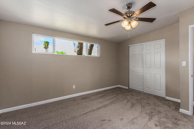 unfurnished bedroom with a closet, lofted ceiling, carpet, and ceiling fan