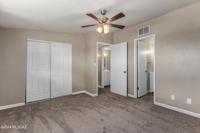 unfurnished bedroom with connected bathroom, carpet, a closet, and ceiling fan