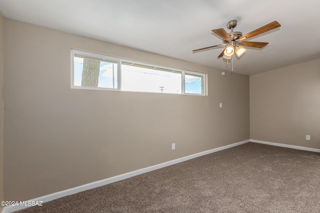 carpeted spare room featuring ceiling fan