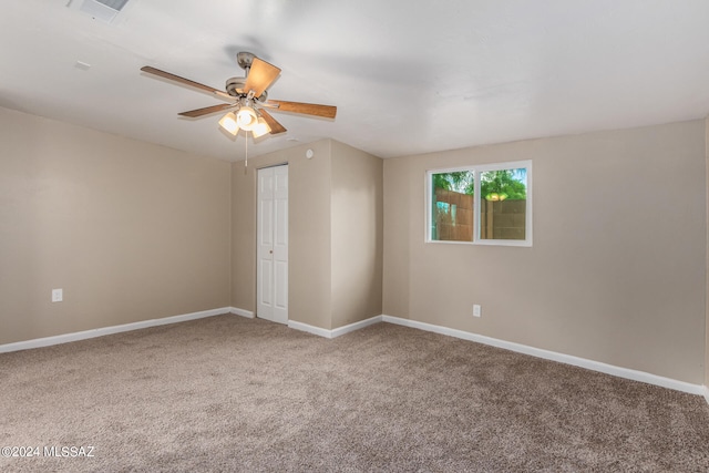 empty room with carpet flooring and ceiling fan