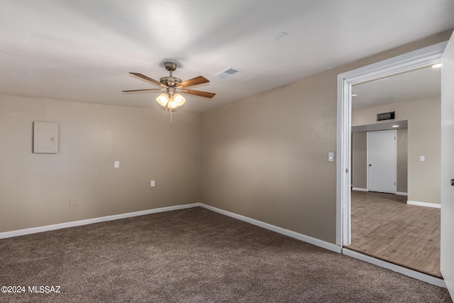 empty room with ceiling fan and carpet flooring