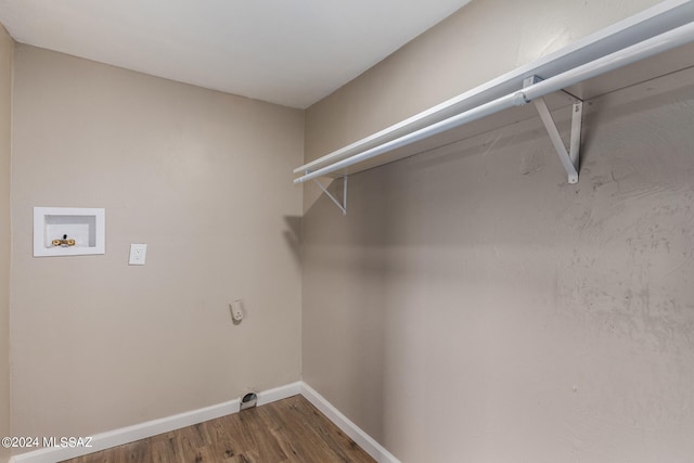 clothes washing area with electric dryer hookup, washer hookup, and wood-type flooring