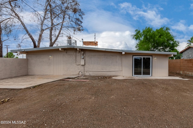 rear view of property with a patio area and central AC unit