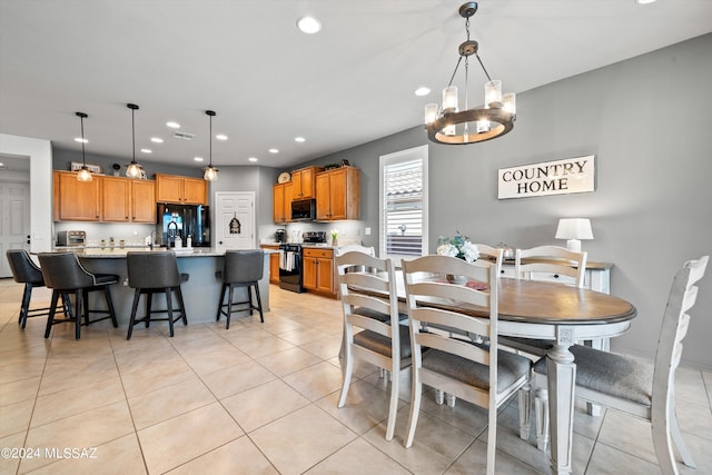 dining area featuring a chandelier and light tile patterned floors