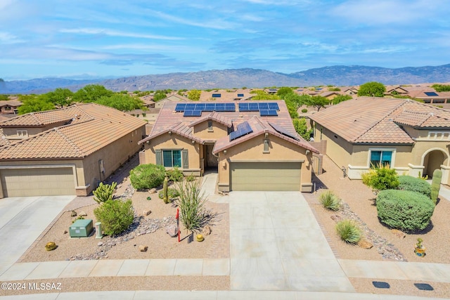 view of front of house featuring a mountain view and a garage