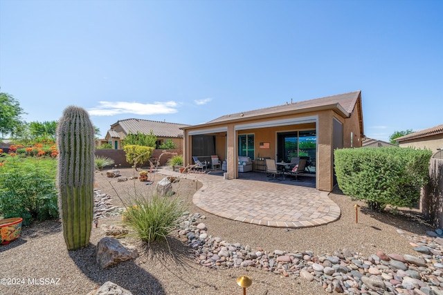 rear view of property featuring a patio area