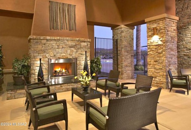 view of patio / terrace with an outdoor living space with a fireplace