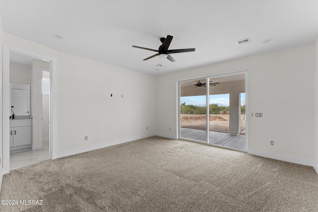 unfurnished room featuring ceiling fan and light carpet