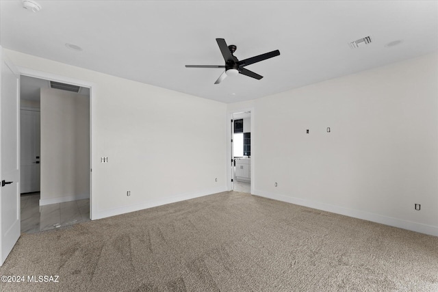 spare room featuring ceiling fan and carpet floors