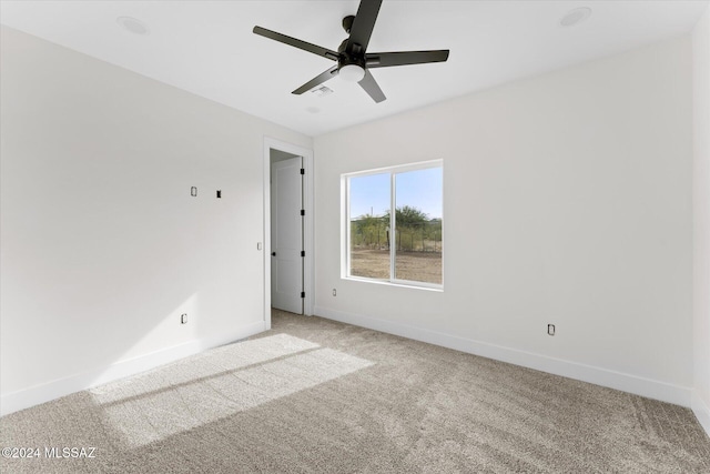 spare room featuring carpet flooring and ceiling fan