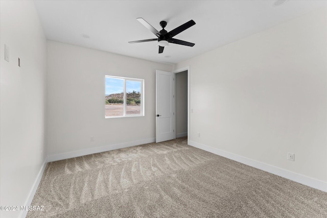 empty room featuring carpet and ceiling fan