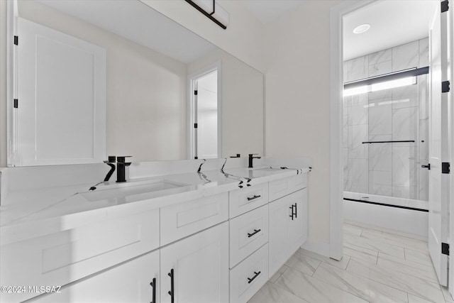 bathroom with shower / bath combination with glass door and vanity