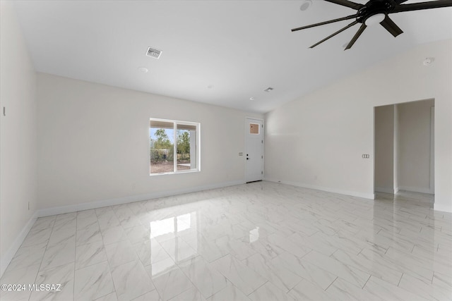 spare room featuring ceiling fan and vaulted ceiling