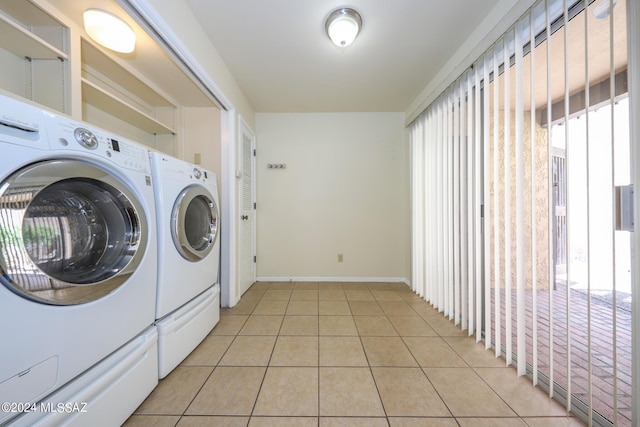 laundry room with separate washer and dryer and light tile patterned floors