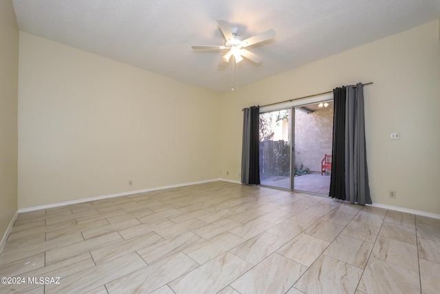 empty room featuring ceiling fan and a textured ceiling