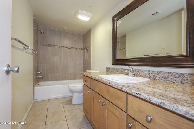 full bathroom with tile patterned floors, vanity, tiled shower / bath combo, and toilet