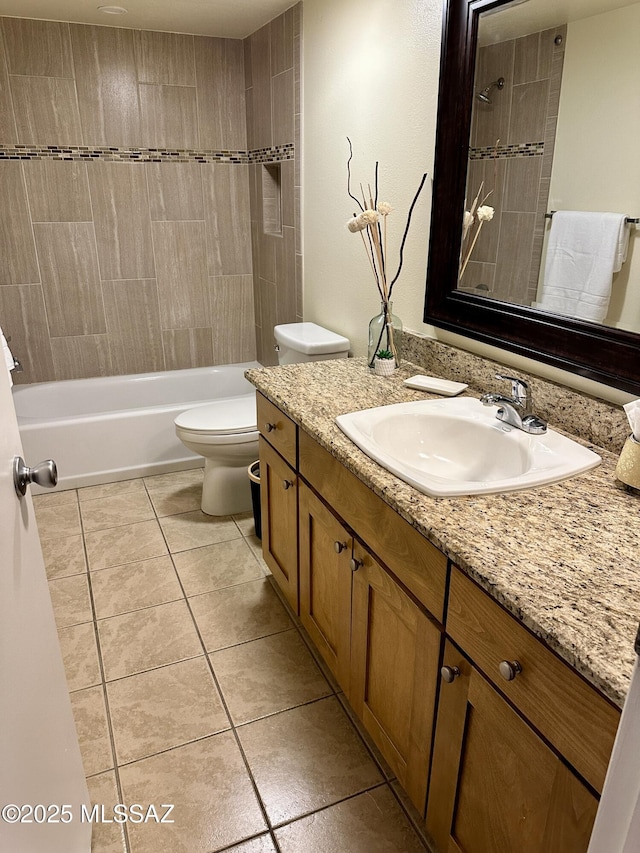 full bathroom with tile patterned flooring, vanity, toilet, and tiled shower / bath combo