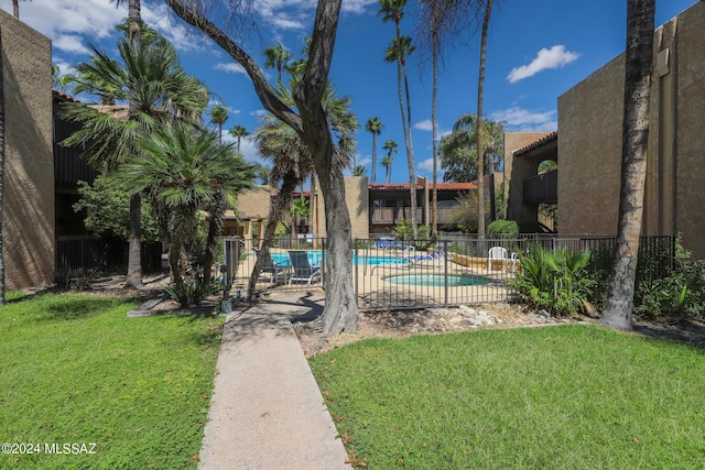 view of swimming pool featuring a lawn