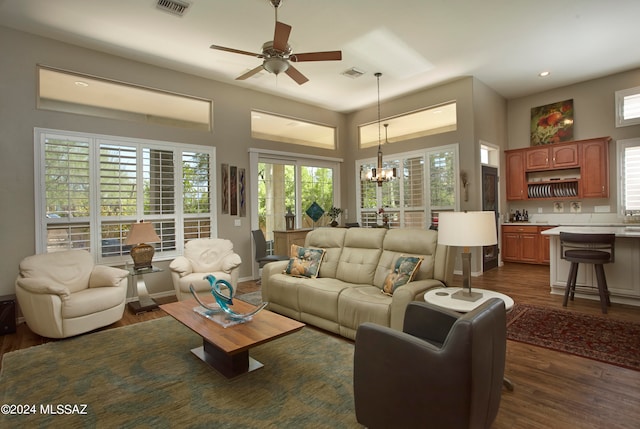 living room with dark hardwood / wood-style floors and a healthy amount of sunlight