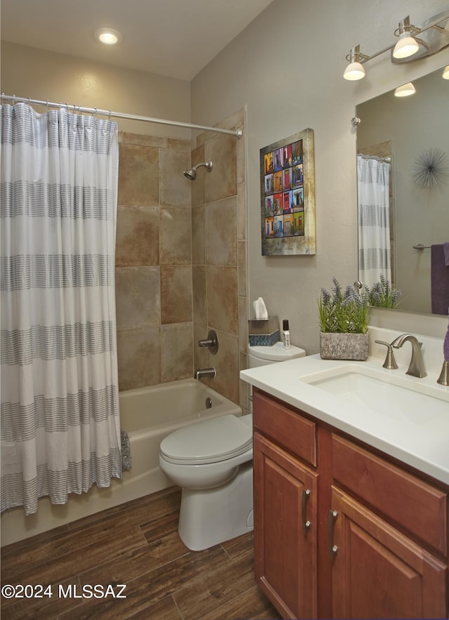 bathroom featuring toilet, wood finished floors, vanity, and shower / bath combination with curtain
