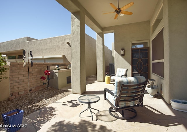view of patio featuring area for grilling and a ceiling fan