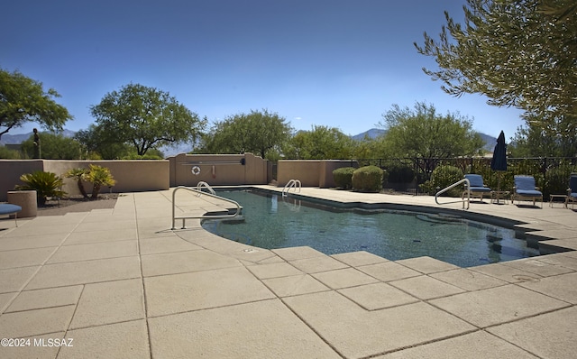 view of pool featuring a fenced in pool, fence, and a patio