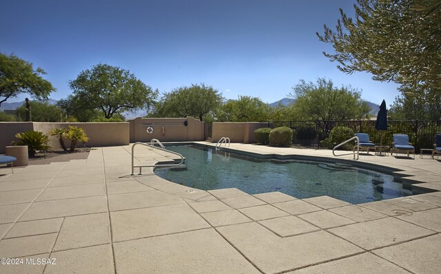 view of swimming pool with a patio area