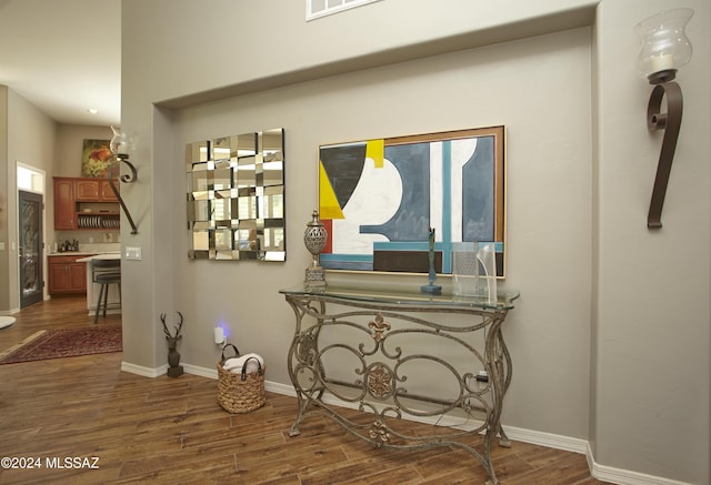 hall featuring baseboards and dark wood finished floors