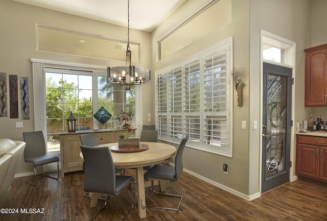 dining room with baseboards, a notable chandelier, and dark wood-style flooring